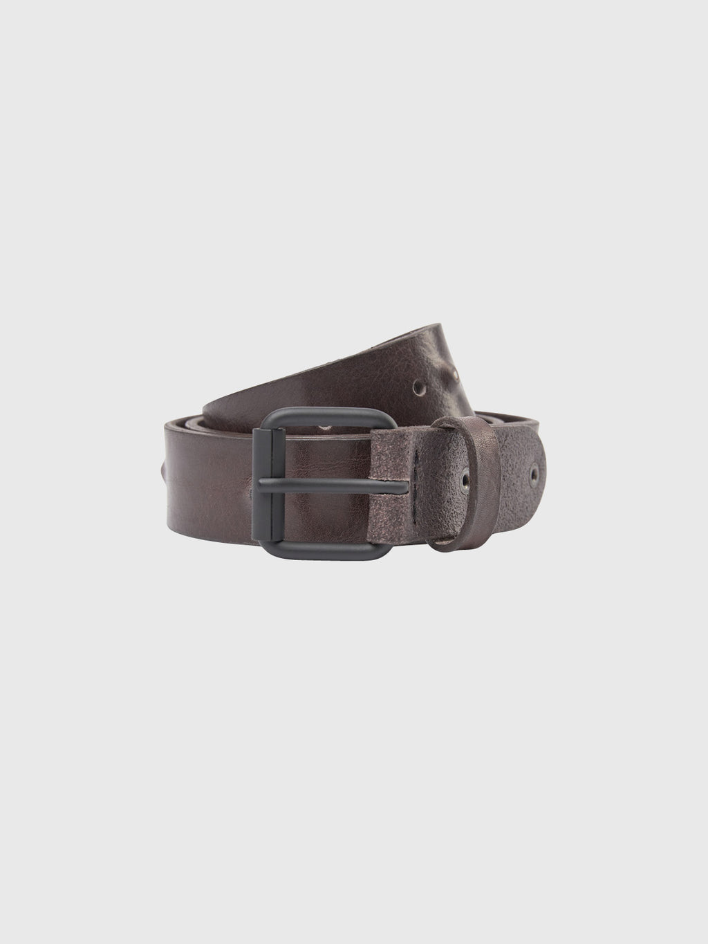 The Okay Point Belt - Brown by GABBA is a classic dark brown leather belt with a rugged texture and black metal buckle. Made from premium leather, it features several holes for easy size adjustment and is elegantly coiled against a plain white background.