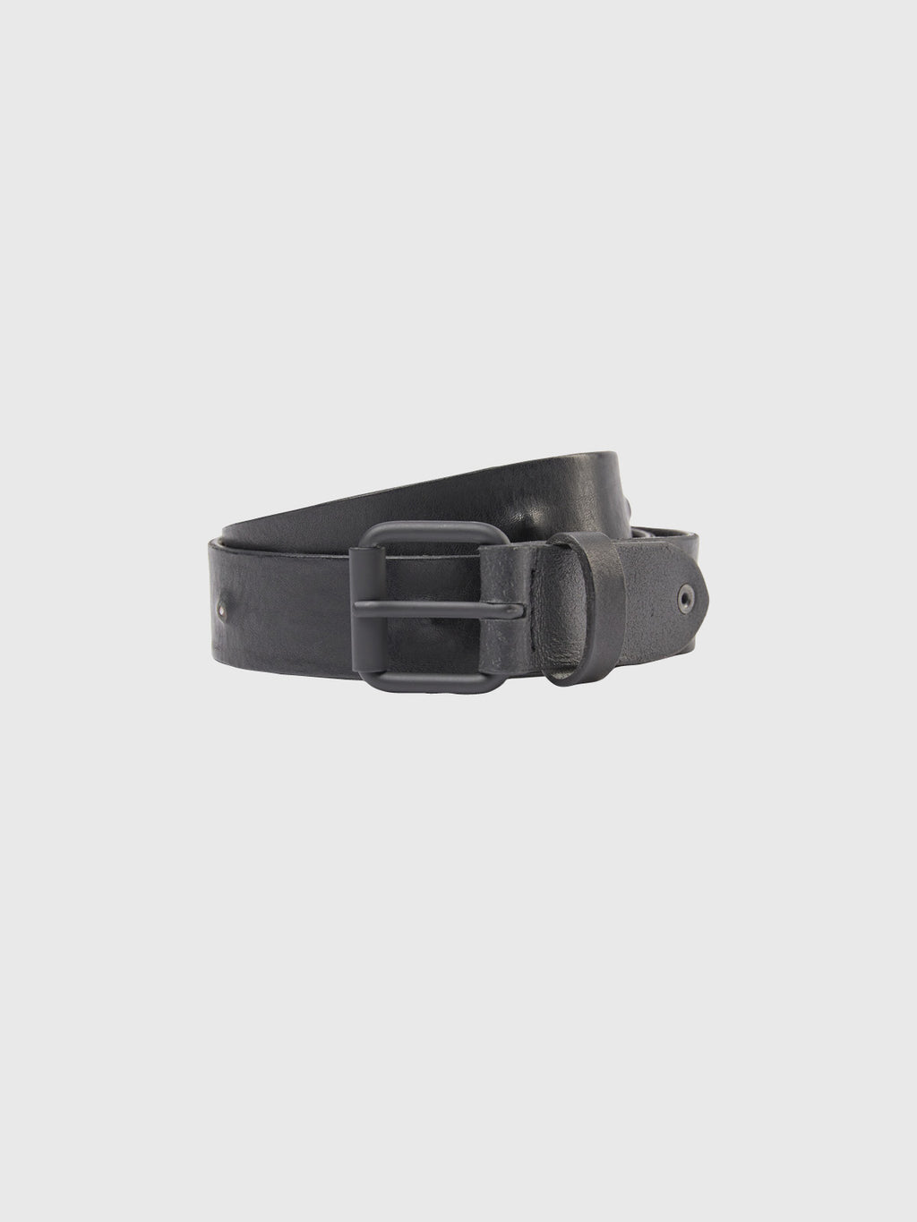 A coiled GABBA Okay Point Belt in premium black leather with a dark metal buckle rests elegantly against a light grey background, showcasing timeless style.