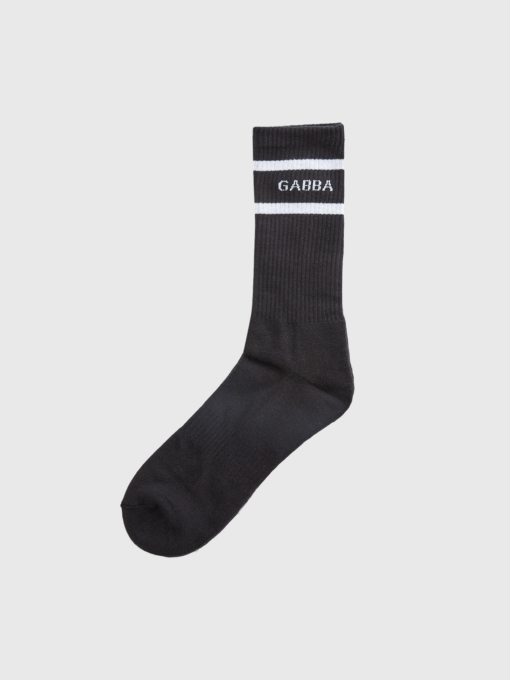 The Loris Socks - Black by Gabba are perfect for daily wear, featuring a ribbed texture with two white stripes near the top and GABBA elegantly centered between them in crisp white, offering both style and comfort against a plain gray background.