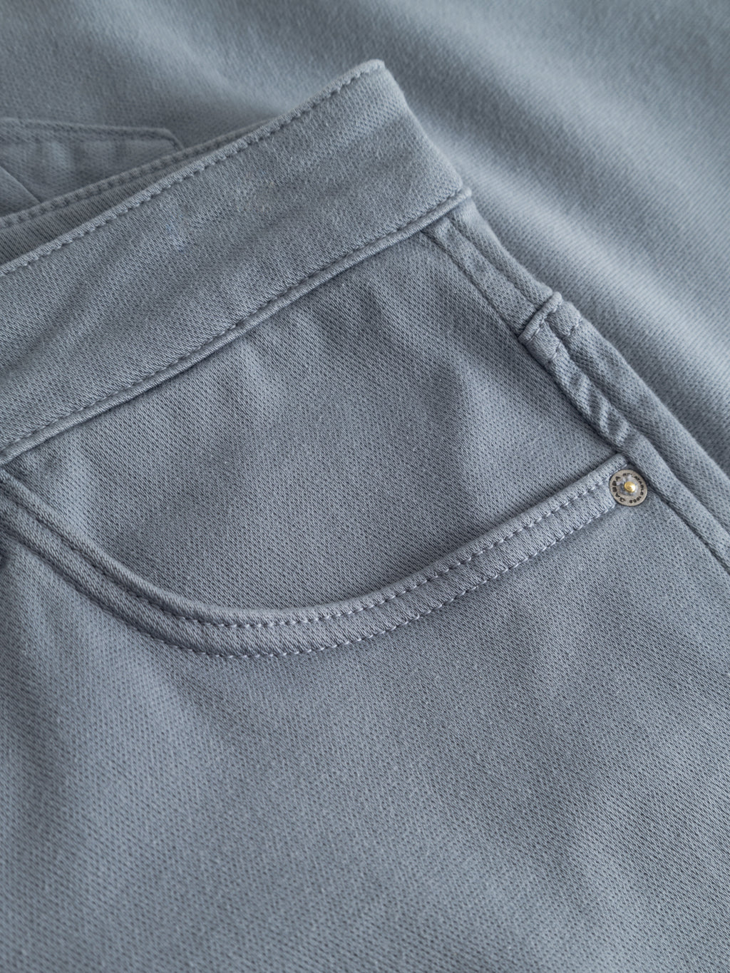Close-up of the front pocket on Gabba GABjason K3995 SANZA Shorts in denim blue, highlighting stitching detail and a metal rivet. Made from super stretch fabric for enhanced comfort and flexibility.