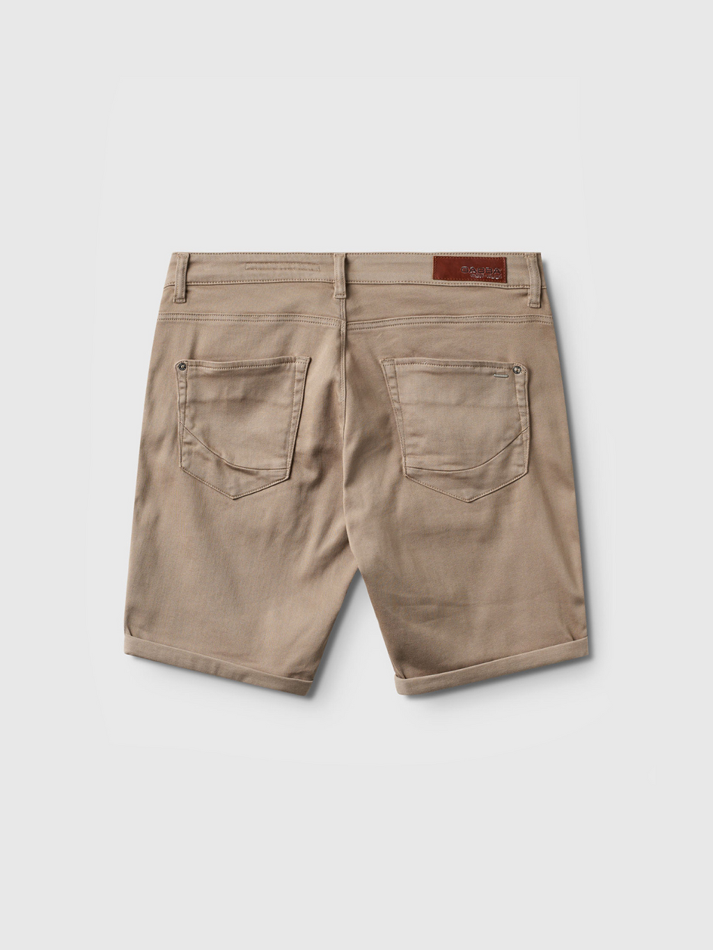 Gabba Jason K3995 SANZA Shorts in Coriander, knee-length beige denim with two rear pockets, belt loops, and a brown leather patch on the waistband, shown from the back against a plain white background.