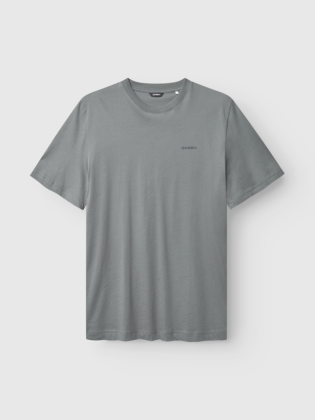 The Gabba Dune Logo SS GOTS in Dust Sage Green is a short-sleeved t-shirt with a round neckline and a small logo on the left chest, made from GOTS-certified organic cotton and shown on a white background.
