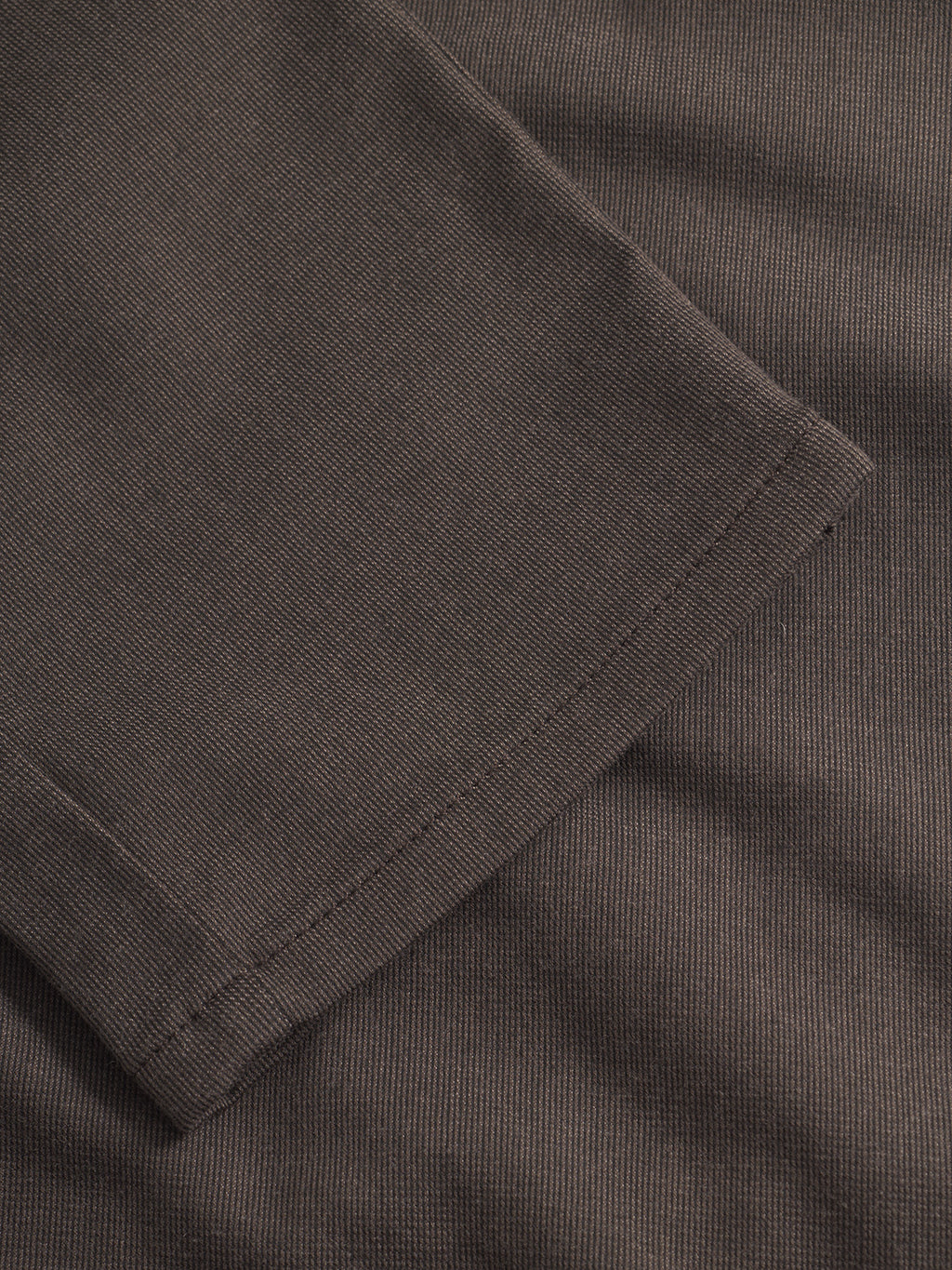 Close-up of Paul Domo - Dk. Brown by Gabba: dark brown ribbed fabric with visible stitching and a detailed sleeve hem—ideal for pairing with slim chino pants for a crisp, modern look.