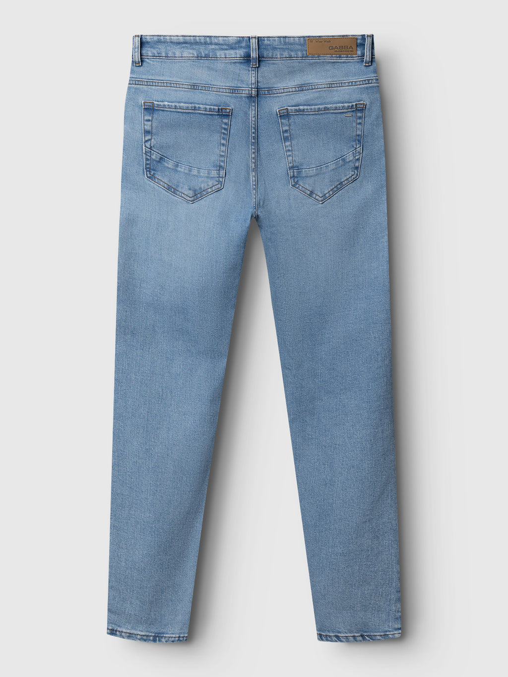 Back view of Gabba Marc F1012 - Lt. Blue Denim jeans features two back pockets, light stitching, and a brown leather patch on the waistband. These regular fit jeans display a modern classic style against a plain white background.