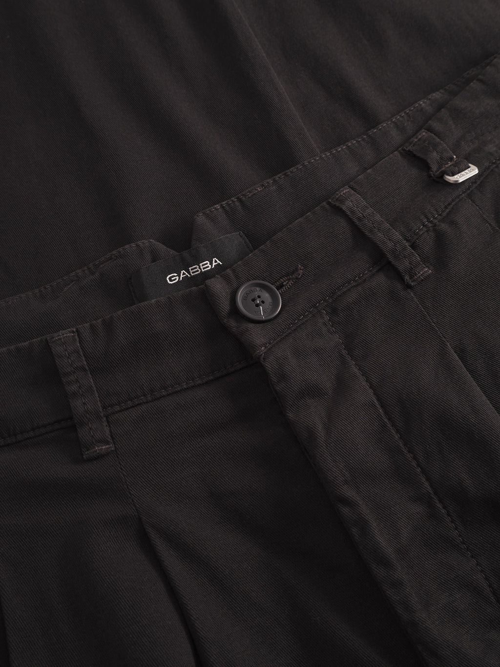 Close-up of Gabba Firenze Lubo - Black pants, highlighting the relaxed tapered fit, waistband, button, belt loops, partial zipper area, and visible Gabba label above the button.