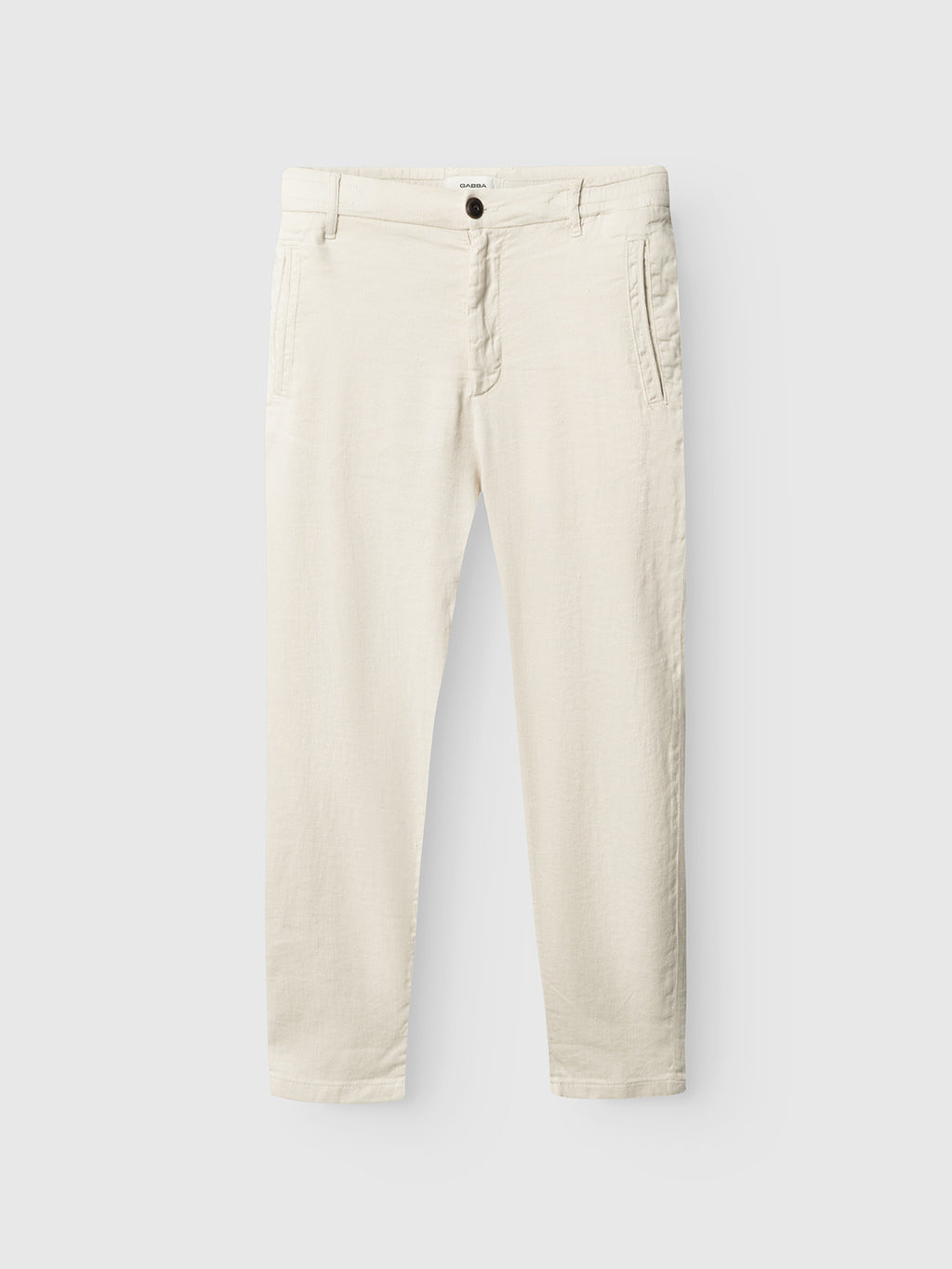 Gabba Monza Twill Linen - Birch: relaxed straight light beige pants featuring side pockets, belt loops, and a button-zip closure, shown laid flat on a white background.