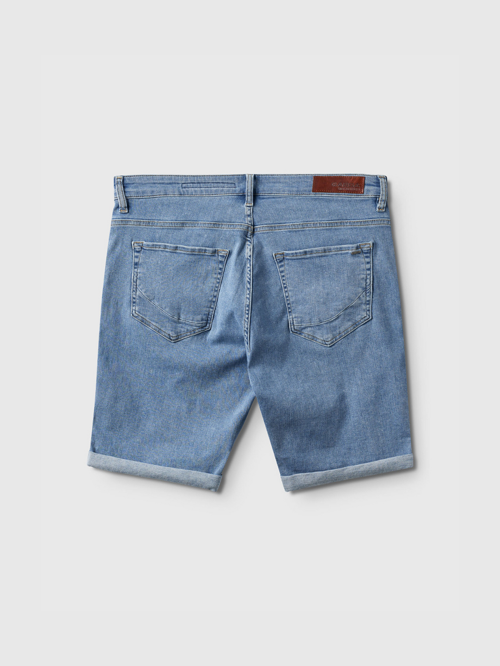 Back view of Gabba Markus K3987 Shorts in light blue denim, featuring rolled cuffs, two back pockets, belt loops, and a brown leather patch on the waistband. Comfortable fit shown on a plain white background.