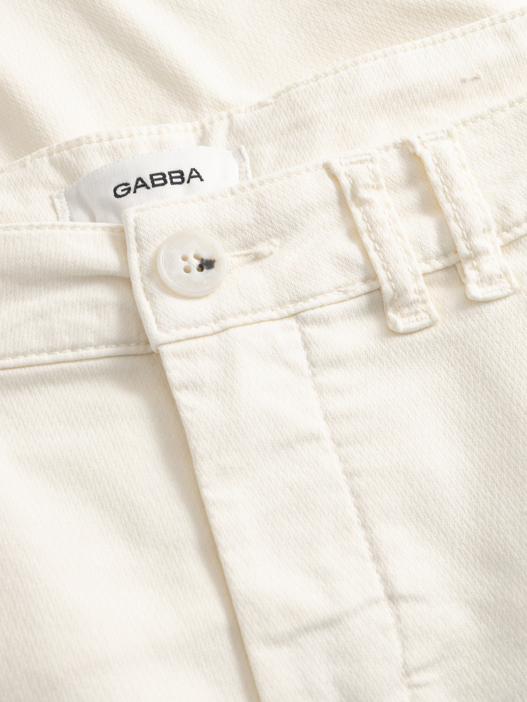 Close-up of the waistband and button of Gabba GABjet K3280 Dale Shorts in white, showing the visible Gabba label sewn inside and textured fabric, ideal for everyday wear.