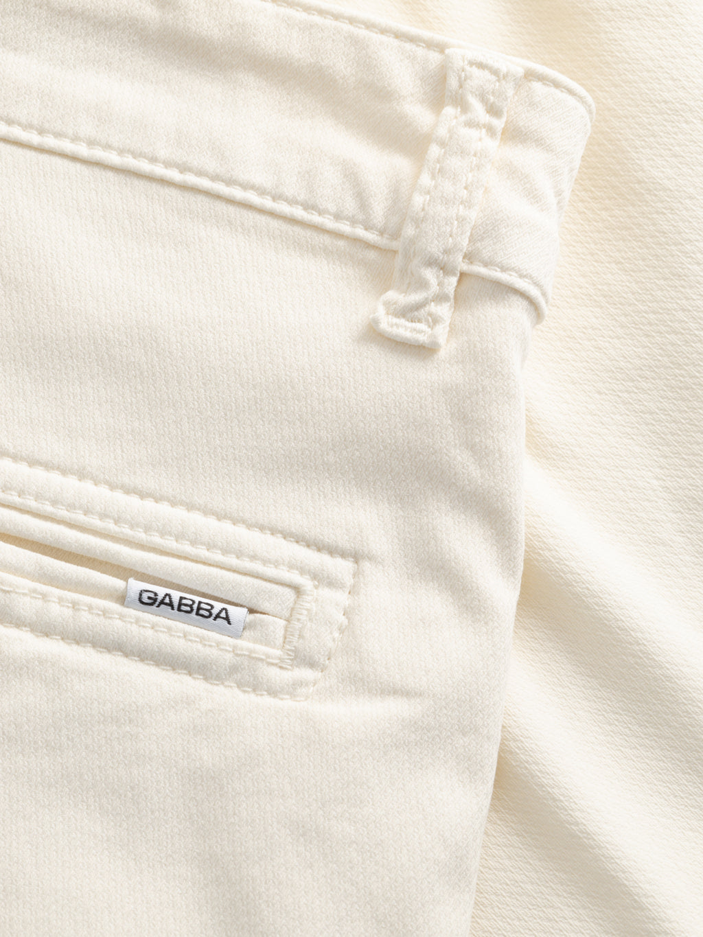 Close-up of the Gabba GABjet K3280 Dale Shorts in white, featuring off-white textured fabric, a pocket with a small GABBA tag, and a belt loop above it—ideal for relaxed-fit comfort and everyday wear.