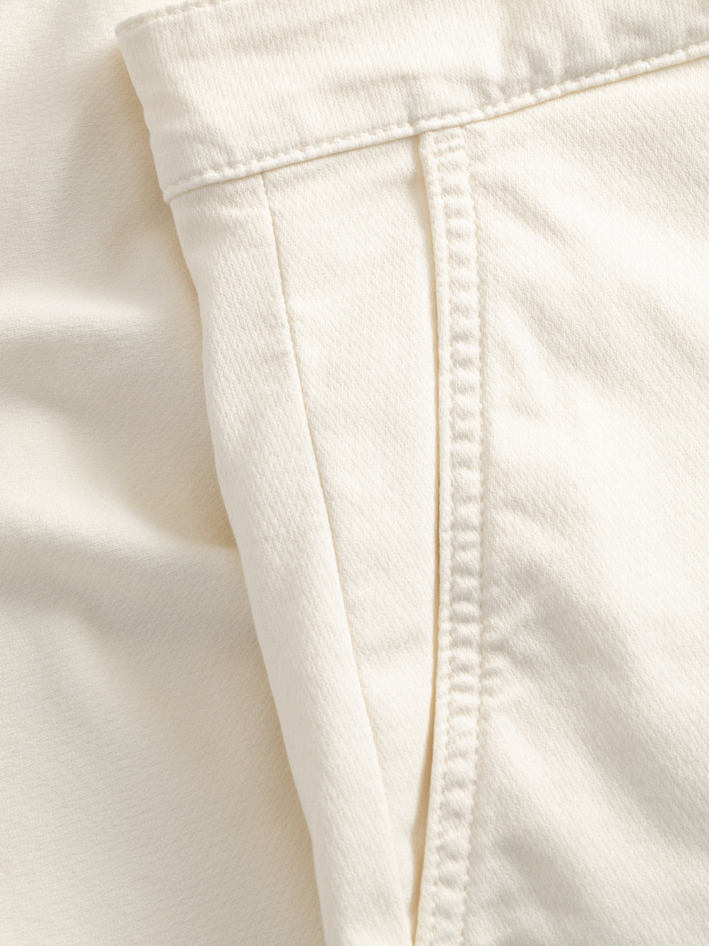 Close-up of the GABjet K3280 Dale Shorts - White by Gabba, featuring cream-colored textured fabric with visible side pocket and seam details. The relaxed-fit design showcases quality stitching for everyday comfort and style.