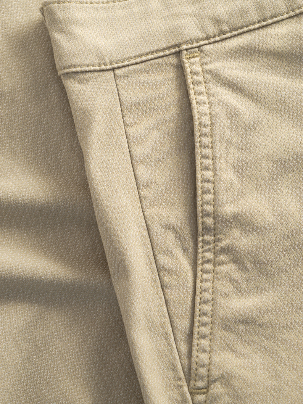 Close-up of Gabba's GABjet K3280 Dale Shorts in Alfa Green, showing the front pocket and side seam. The textured fabric and visible stitching along the pocket edge and waistband highlight their casual style.