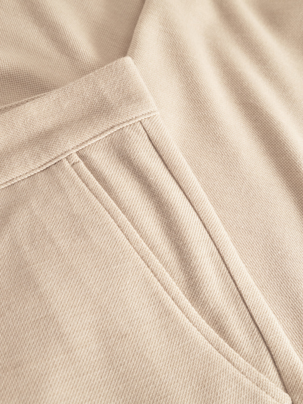 Close-up of Gabbas Paul GKnit - Sand Plaza shows soft, ribbed beige fabric with a visible seam and stitched pocket detail—highlighting the fine knitting and texture typical of comfortable everyday wear.