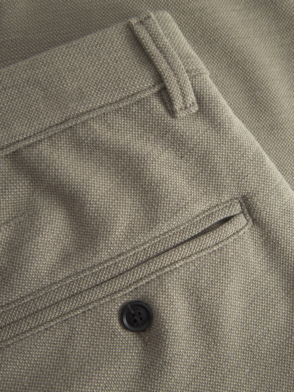 Close-up of the back pocket on Gabba Paul GKnit - Light Green pants, highlighting the buttoned pocket and belt loop on slim fit, textured woven fabric.