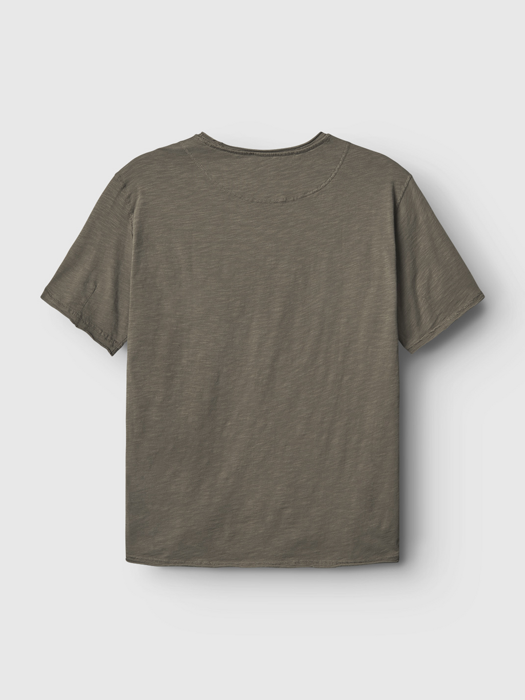 The Gabba Kostant SS in light brown is a plain, short-sleeve regular fit t-shirt shown from the back against a light gray background. Made from midweight slub jersey, it features a simple design with no visible logos or designs.