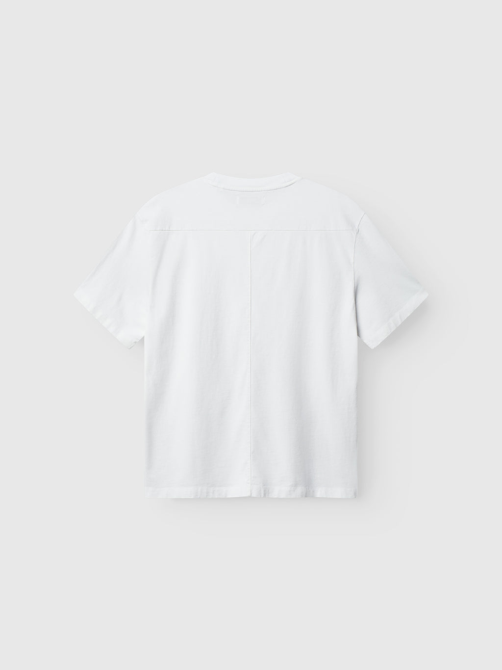 Back view of the Gabba Nigel Wix Boxy Hour SS t-shirt in white, shown against a light gray background. Features a modern boxy fit and a distinct vertical center seam for subtle detailing.