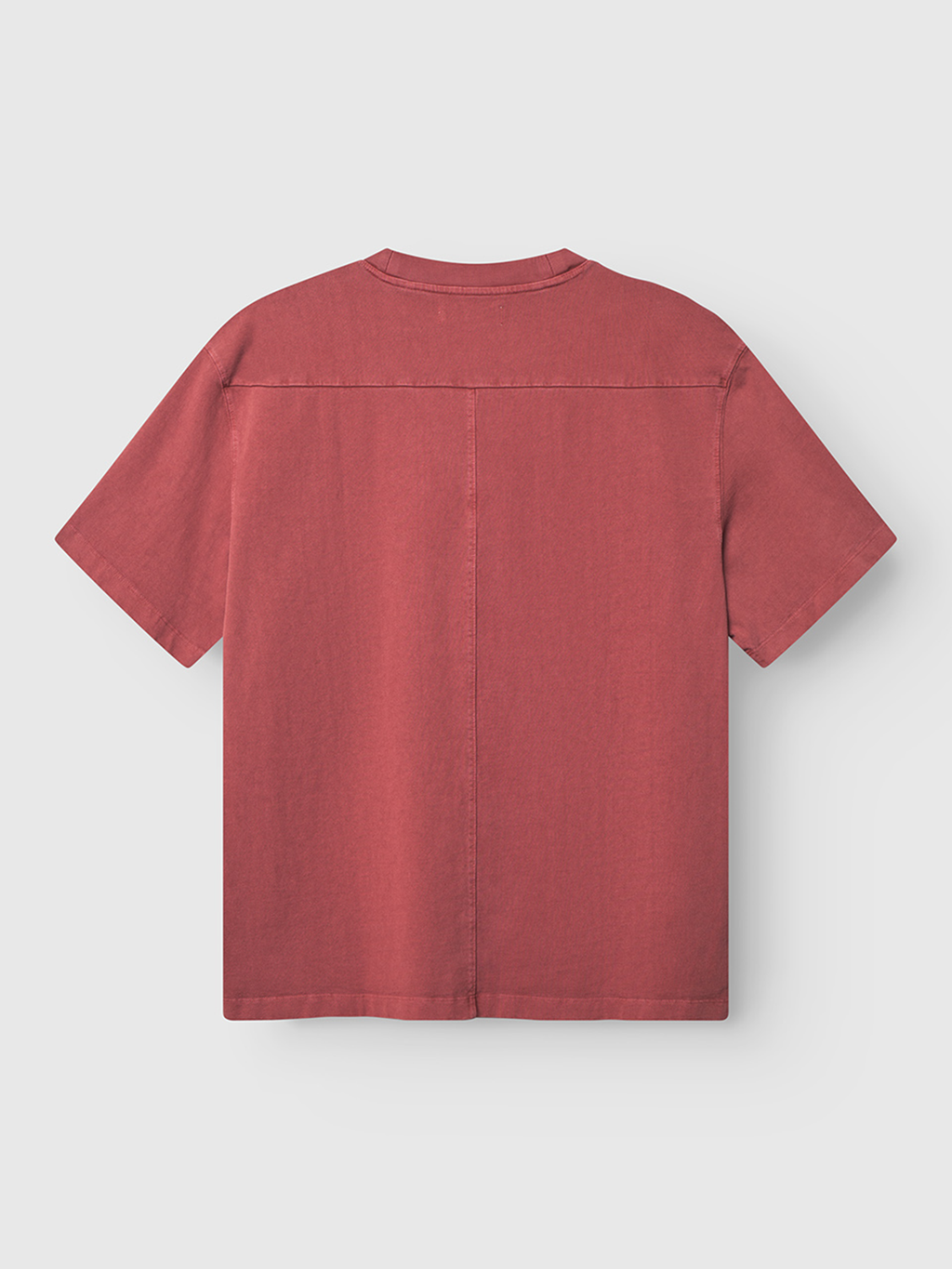 The Gabba Nigel Wix Boxy Hour SS in Red Russet is shown from the back against a light gray background, featuring short sleeves, a boxy fit, and visible horizontal and vertical seams across the upper back and center.