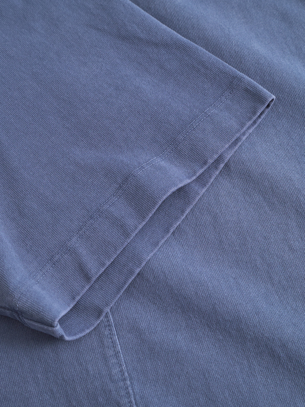 Close-up of the hem and sleeve on the Gabba Nigel Wix Boxy Hour SS in vintage indigo, showcasing its fine stitching and heavyweight cotton fabric.