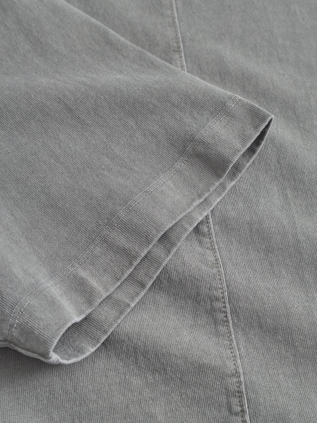 Close-up of the Gabba Nigel Wix Boxy Hour SS in Dust Sage Green, showcasing the sleeve hem and stitching on soft, vintage-textured cotton fabric.