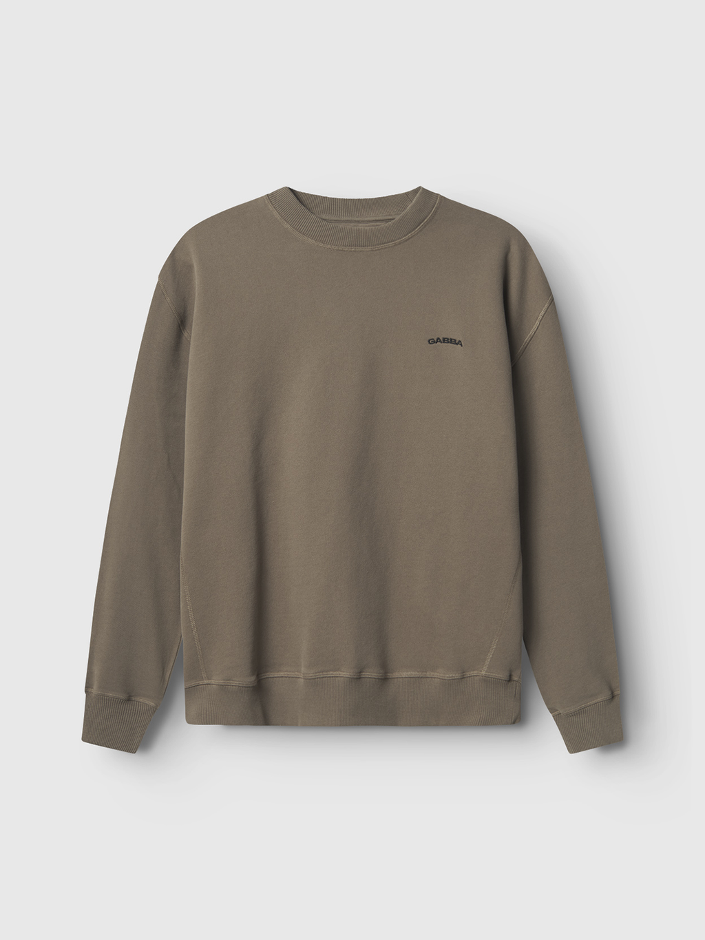 An olive green crewneck sweatshirt with a super soft handfeel and minimal design, featuring the dark Gabba logo on the left chest. It has long sleeves, ribbed cuffs, and hem, all set against a light gray background.
