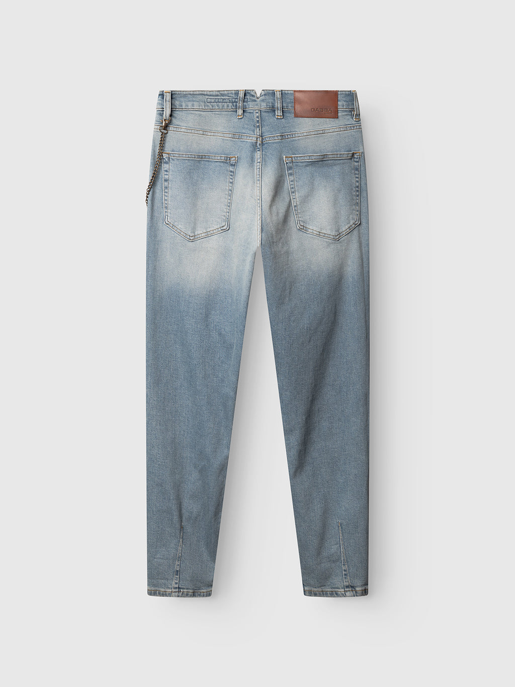 The Gabba GABalex Cros Cropped light blue denim jeans, made from recycled cotton, feature a relaxed fit, faded details, two back pockets, a brown leather patch on the waistband, and a metal chain on a belt loop.