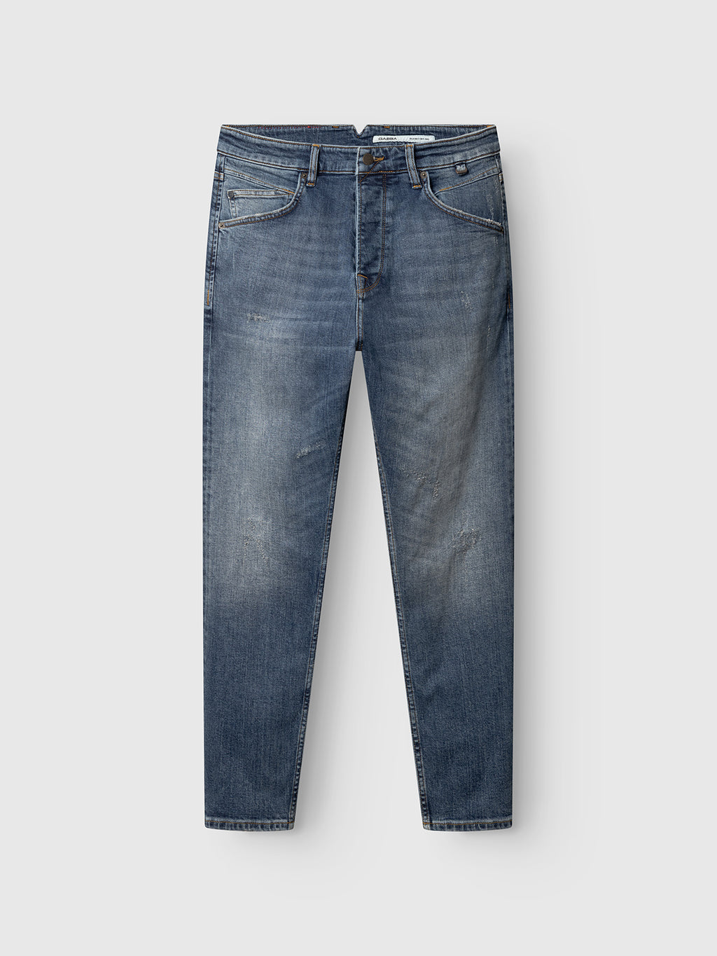 The GABalex Cros Cropped jeans by Gabba feature a relaxed fit in mid blue denim with a faded, distressed look, front and back pockets, belt loops, button fly, and are made from recycled cotton. Shown flat on a light gray background.