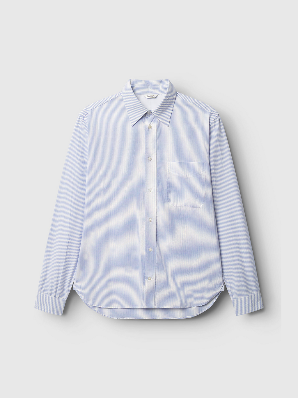 The Gabba Sven Reg. Form LS - White Stripe is a premium 100% cotton yarn-dyed striped shirt, featuring a blue and white pattern, long sleeves, a button-down style, and a left-side pocket against a plain gray background.