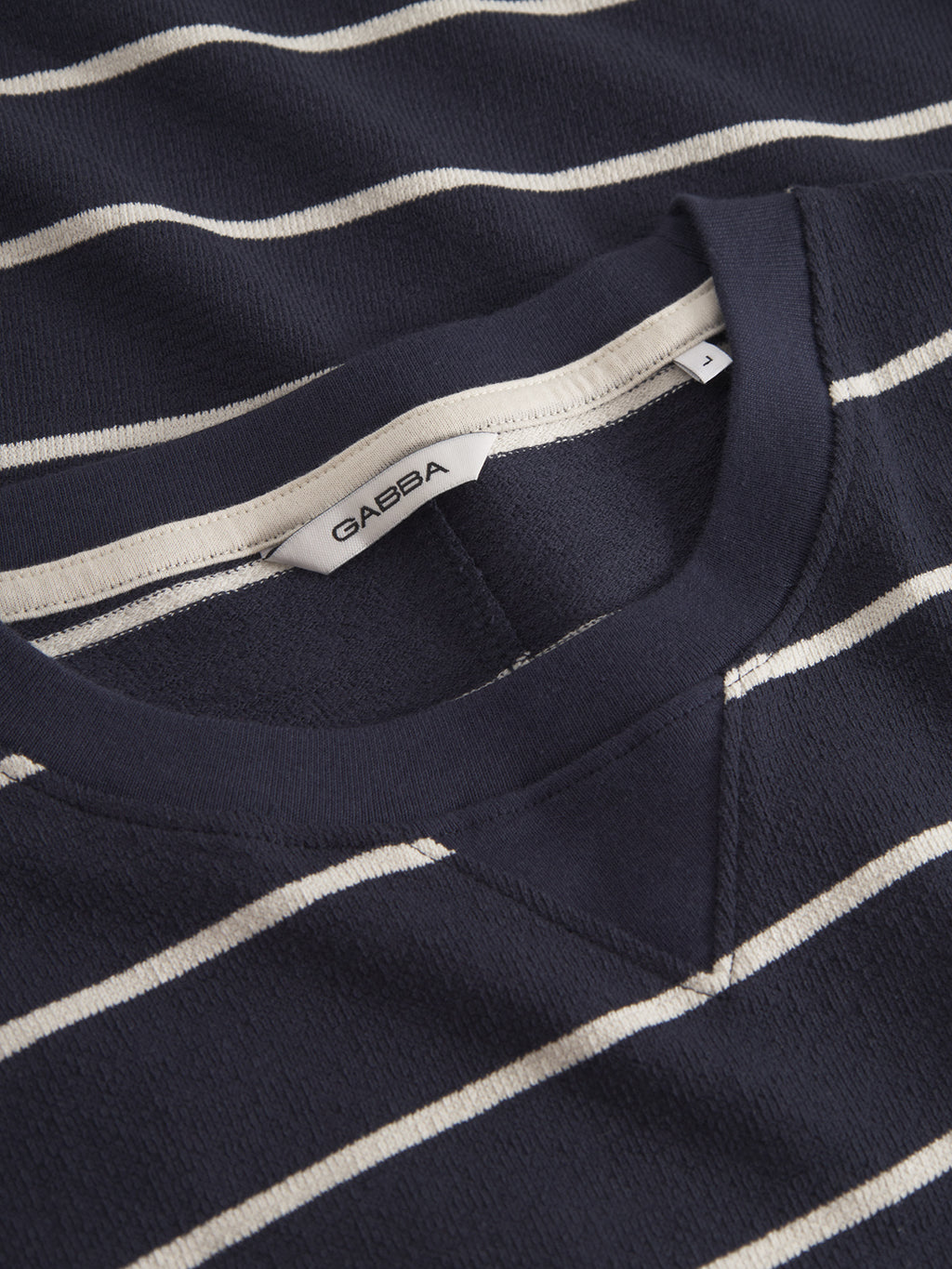 Close-up of the Gabba Dune Crepe Stripes SS GOTS t-shirt in navy stripe, a classic fit with white horizontal stripes, round neckline, and visible Gabba label inside the collar.