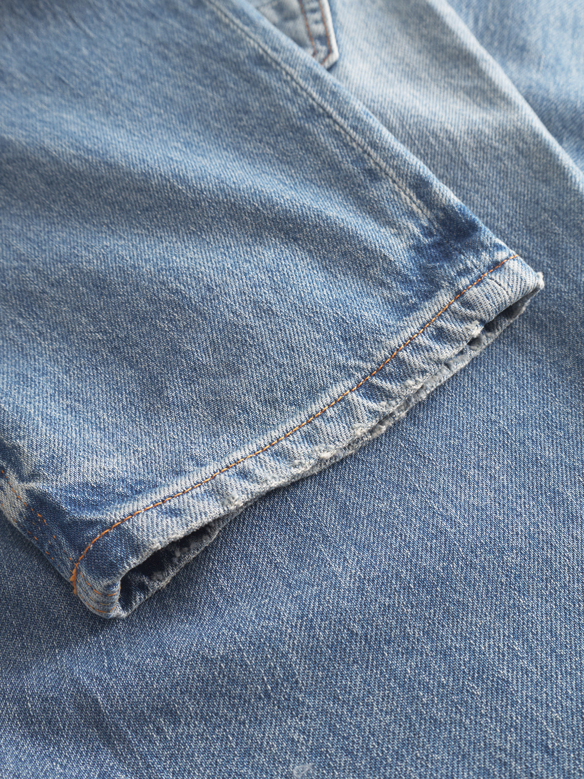 Close-up of Gabbas Carl Astra - Mid Blue Denim jeans, highlighting the hem with slightly faded fabric and visible orange stitching, reflecting a casual and stylish look perfect for comfort and ease.