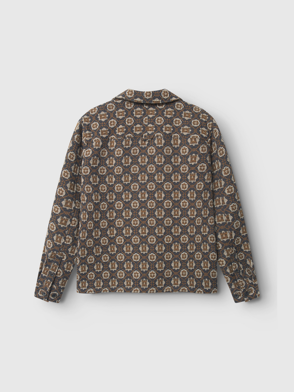 The Gabba Simone Star - Multi Pattern is a premium long-sleeve overshirt featuring a brown, beige, and black geometric floral design. Seen from the back on a light gray background, it includes a collar and buttoned cuffs for subtle style.