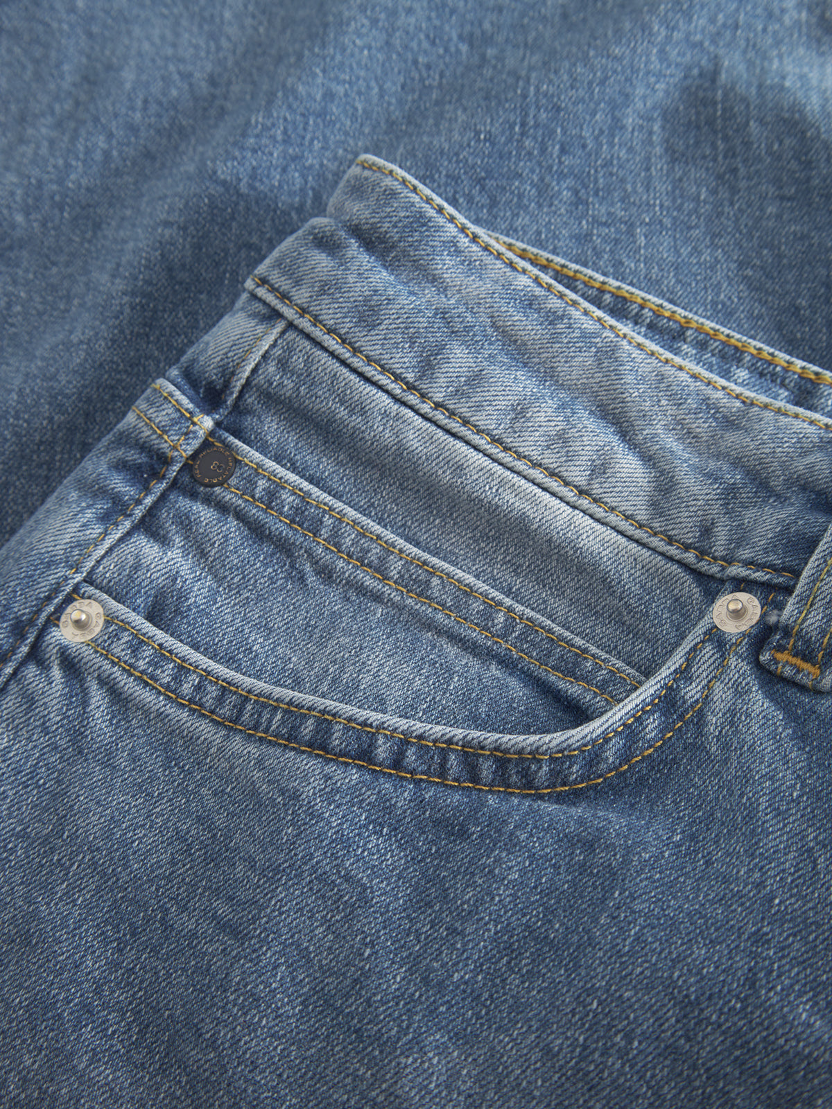 Close-up of Gabbas Marc 5poc in Mid Blue Denim, showcasing a jeans pocket with metal rivets, visible stitching, and textured blue denim that emphasizes its modern classic look and iconic design details.