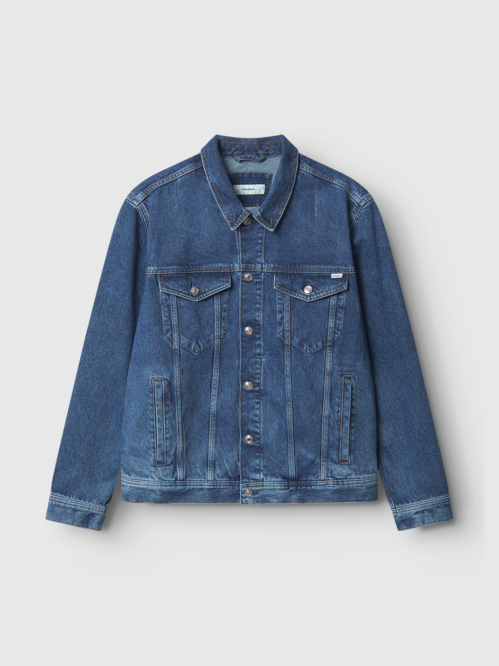 The Gabba Luca Jacket in mid blue denim features contrast stitching, button closure, two chest flap pockets with buttons, and two side pockets, shown against a plain white background.