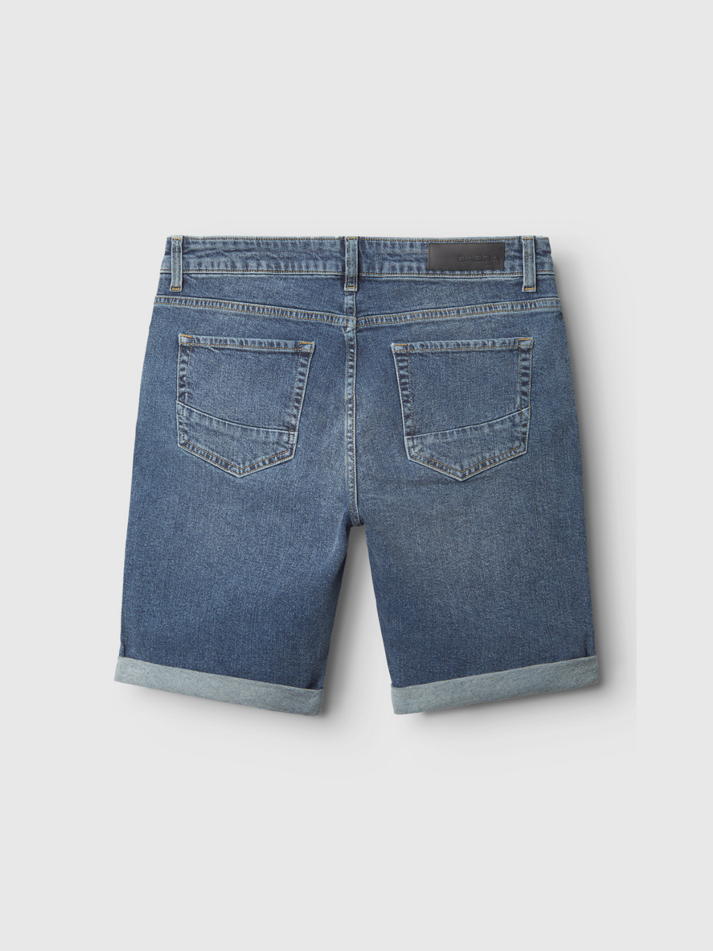 Back view of the Markus 5poc Dark Blue Denim shorts by Gabba, featuring a comfortable fit, rolled hems, two back pockets, belt loops, and a dark patch on the waistband, displayed against a plain white background.