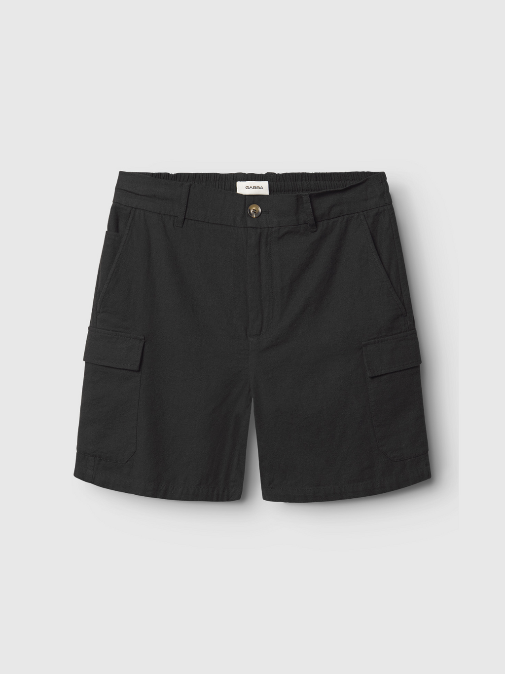 The Gabba Alfa Cargo Lino - Meteorite shorts feature black linen, an elastic waistband, button closure, side pockets, and flap cargo pockets. Made from breathable fabric for comfortable, temperature-regulated wear against a light gray background.