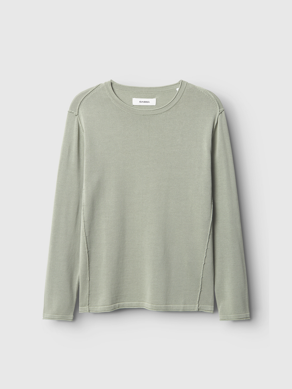 The Gabba Bela Fix LS in light green is a long-sleeve crewneck shirt made from soft, lightweight 100% cotton premium knit, shown flat on a light gray background. Features visible stitching with no extra design or pattern.