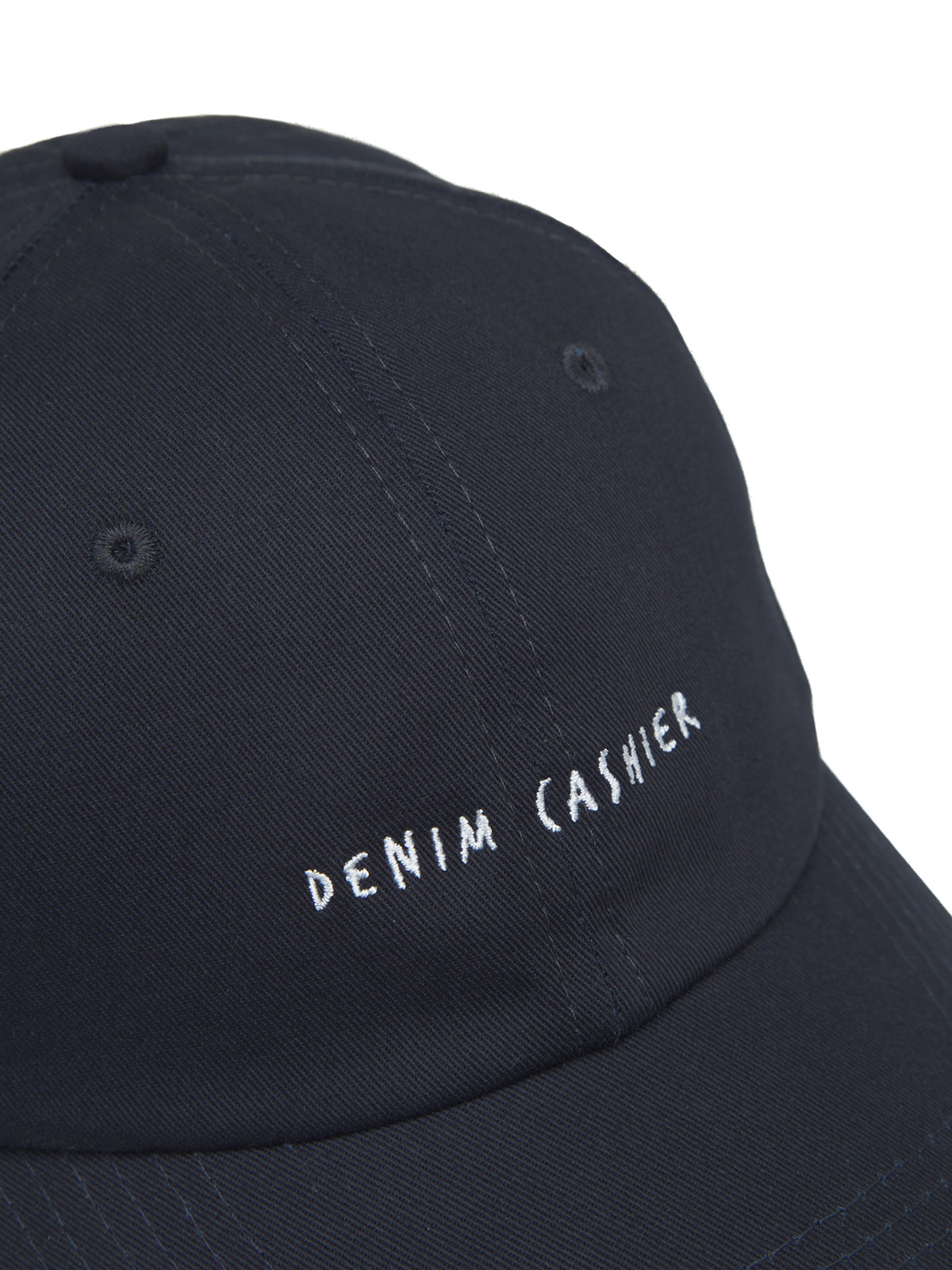 Close-up of the Gabba Cashier Cap - Night Sky in 100% cotton, featuring DENIM CASHIER embroidered in white on the black front panel, along with a top button and stitched ventilation eyelets.