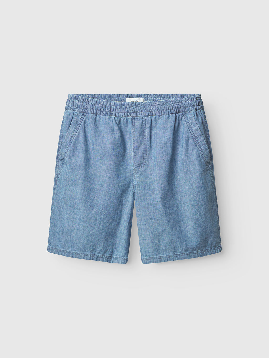Gabba’s Fede Topaz Light Chambray shorts feature an elastic waistband and side pockets, shown against a plain light gray background.