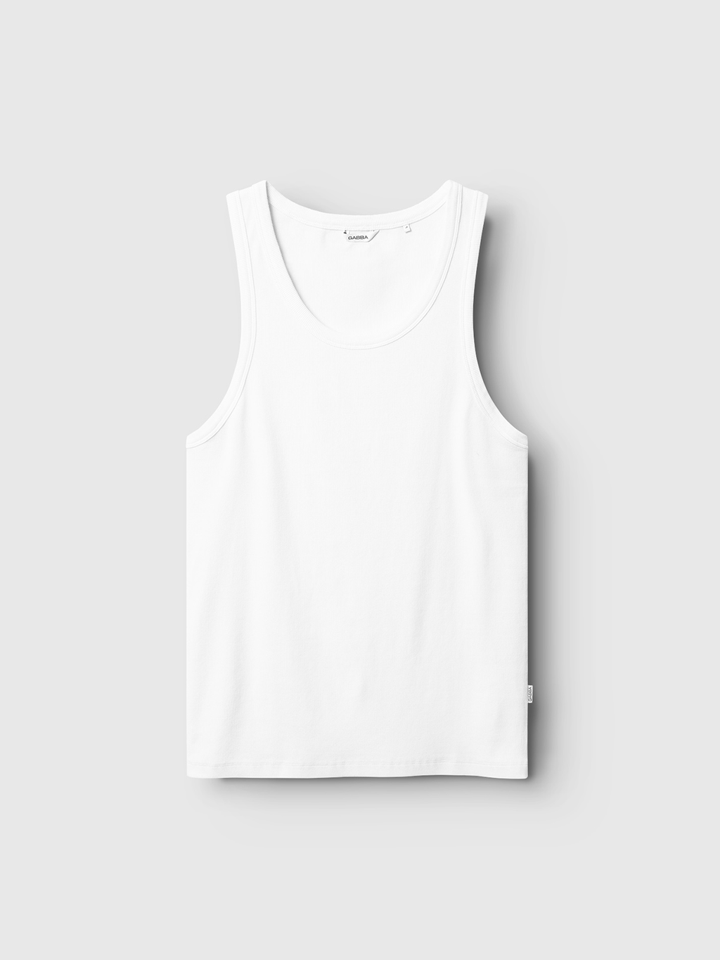 The Orsen - White tank top by Gabba is shown laid flat against a light gray background, highlighting its clean lines and minimalist design—ideal for summer layering.