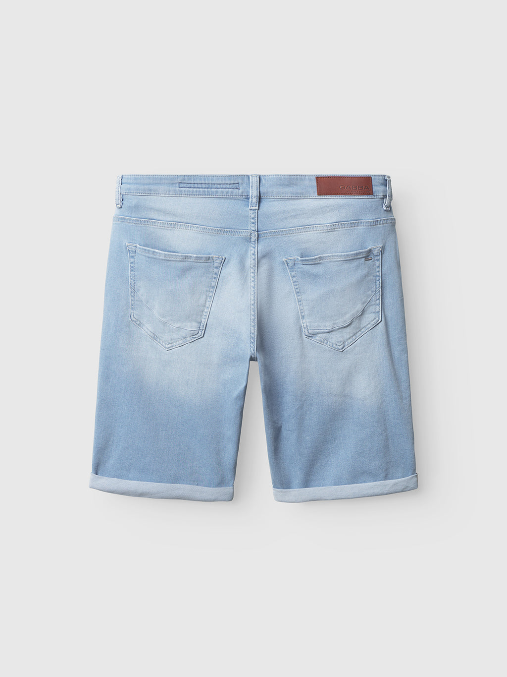 The Gabba Markus K3987 Shorts in light blue denim feature a comfortable fit, two back pockets, rolled-up hems, belt loops, and a brown leather patch on the waistband, shown from the back against a plain light background.