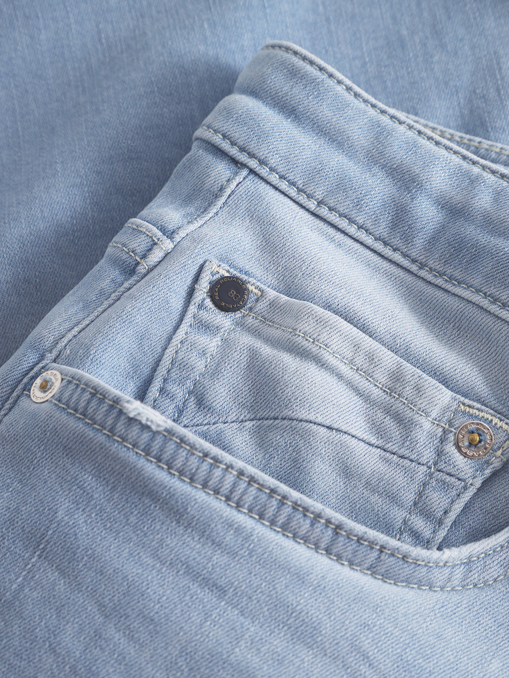 A close-up of Gabba Markus K3987 Shorts in light blue denim, neatly folded to showcase the front pocket, coin pocket, and waistband details on matching denim for a comfortable fit.