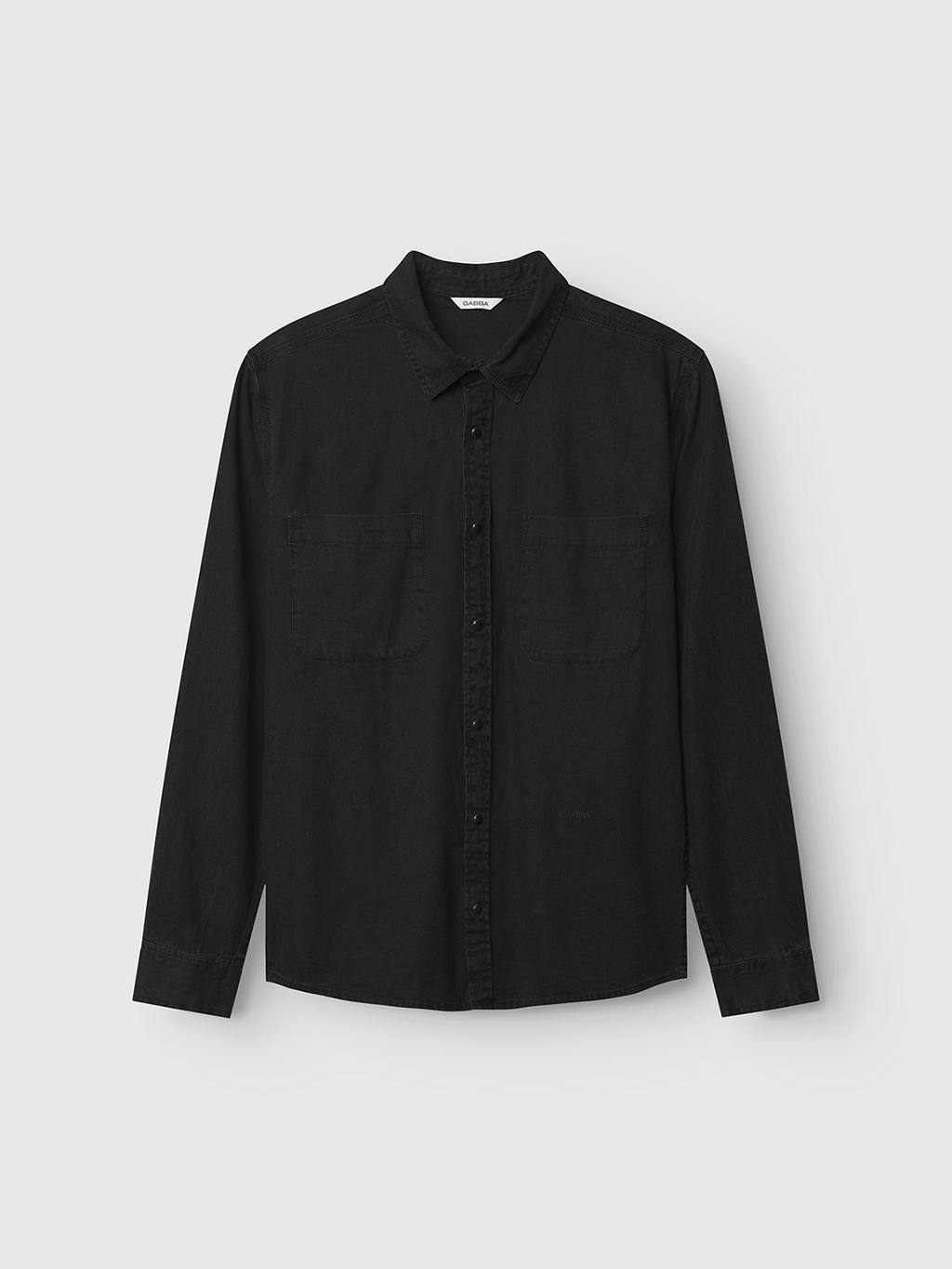 The Gabba Sven Reg Denim LS in black denim is a 100% cotton, collared long-sleeve shirt with double chest pockets, shown on a light gray background.