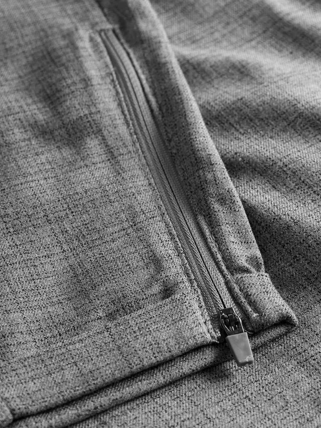 Close-up of the GABBA Pisa Cross Lt Grey pants in light grey, showing a subtle check textured fabric and closed zipper pocket—crafted from high-stretch cotton-blend in the signature Pisa metro style.