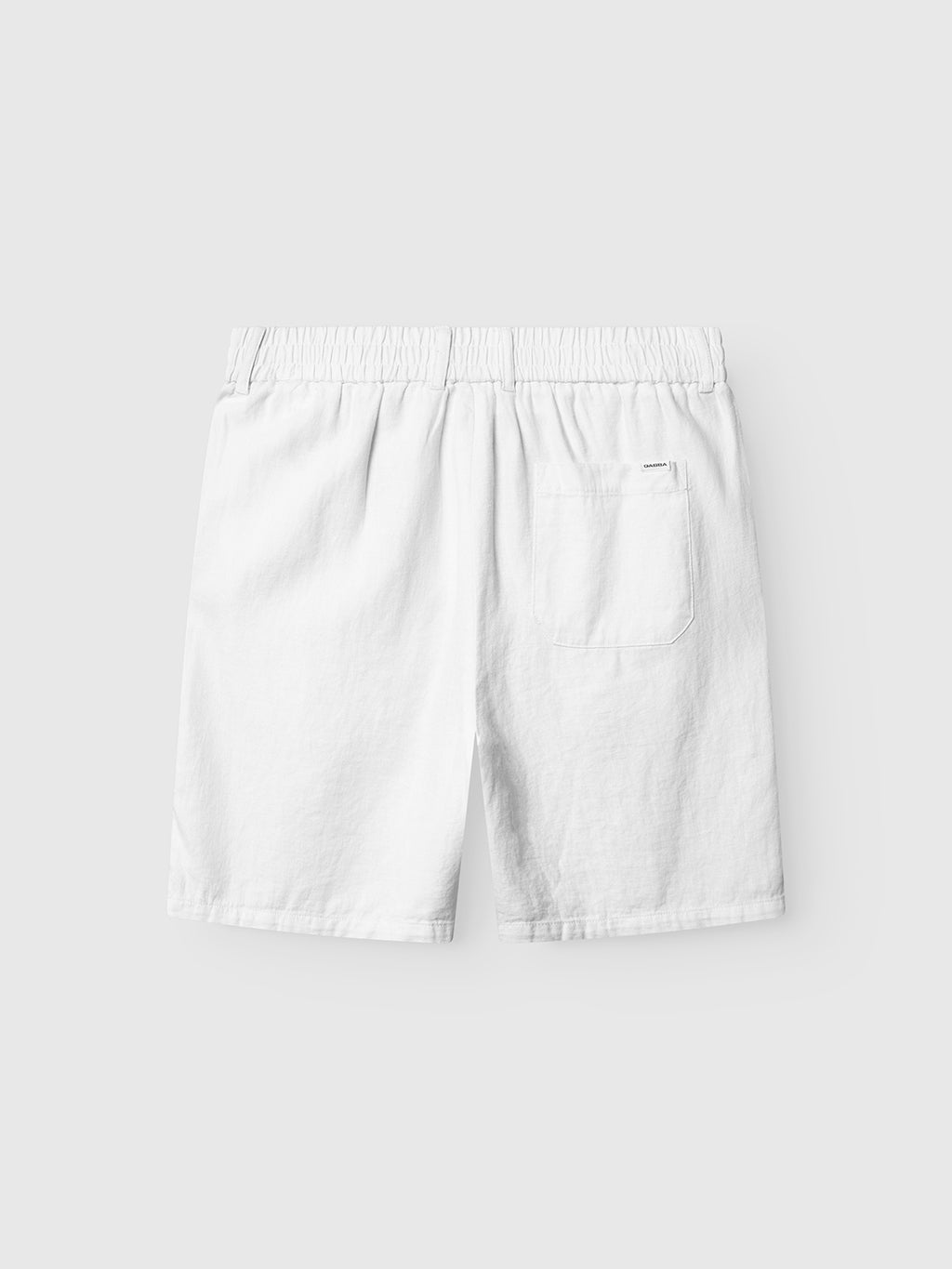 The Gabba Alfa Lino - White shorts feature premium linen, an elastic waistband, and a single back pocket for superior comfort, shown on a light gray background.