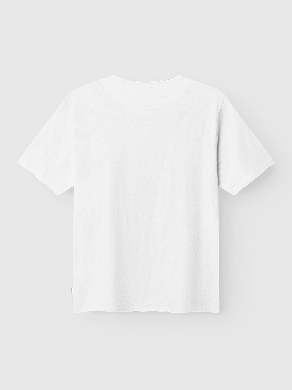 The Gabba Kostant New SS - White is a classic short sleeve slub yarn shirt with minimal styling, no patterns or logos, and a lightweight, breathable feel. Shown from the back against a light gray background.