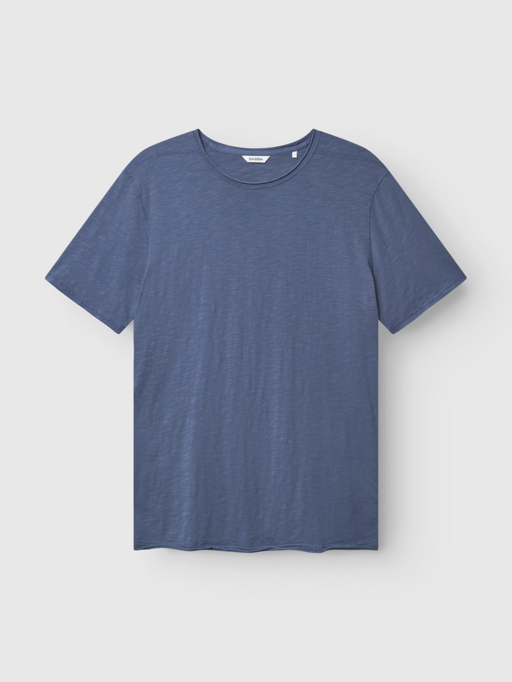 The Gabba Kostant New SS in Vintage Indigo, a short-sleeved crew neck t-shirt made from solid washed cotton slub, is laid flat on a light background.