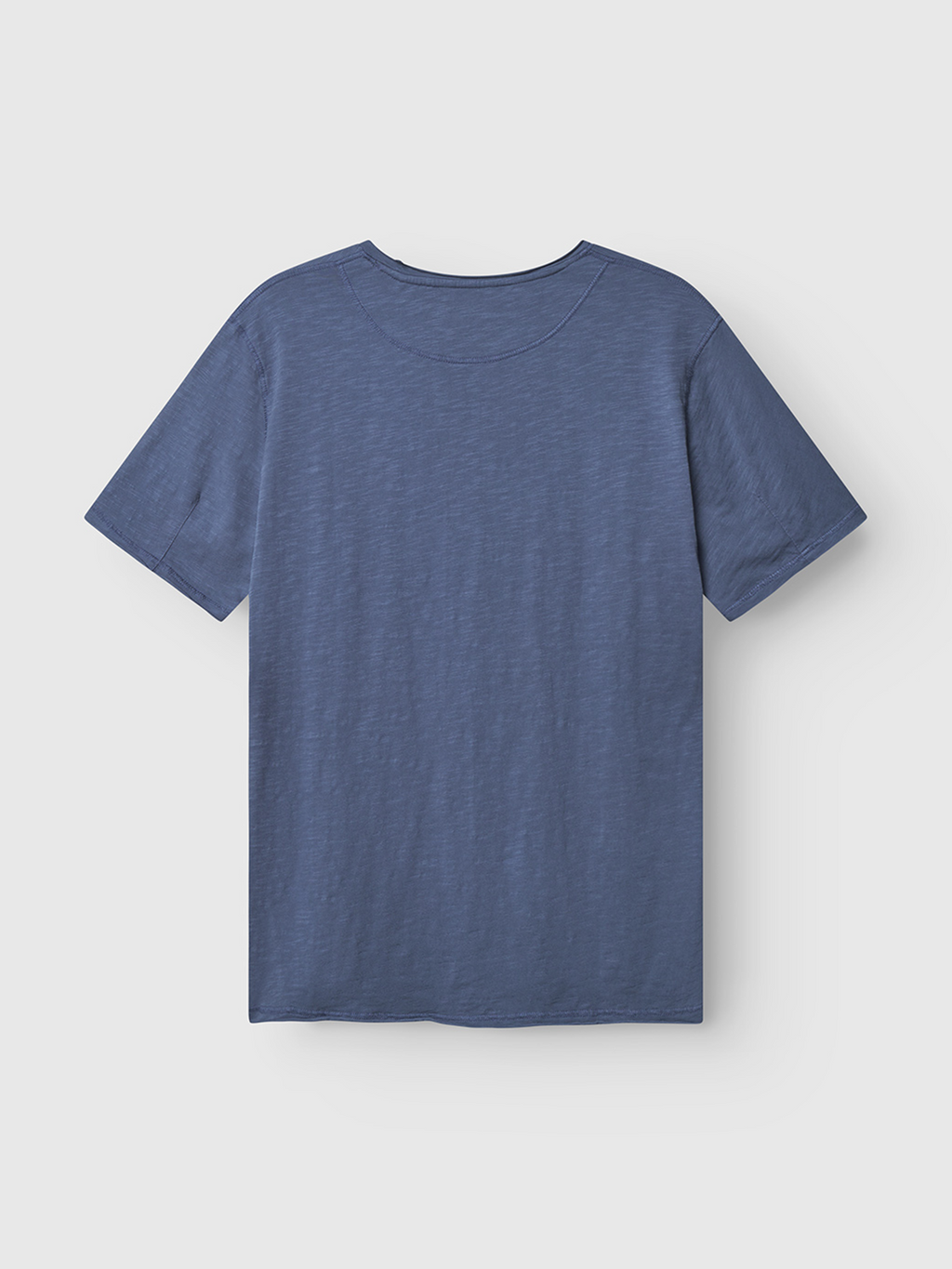 The Gabba Kostant New SS t-shirt in vintage indigo is shown flat on a white background, displayed from the back with short sleeves and a plain design.