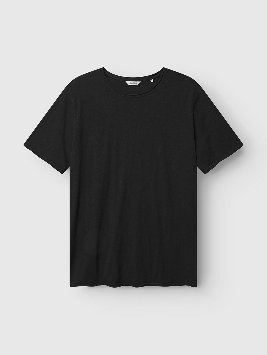 The Gabba Kostant New SS - Meteorite is a relaxed fit, plain black short-sleeve t-shirt shown on a flat light gray background.
