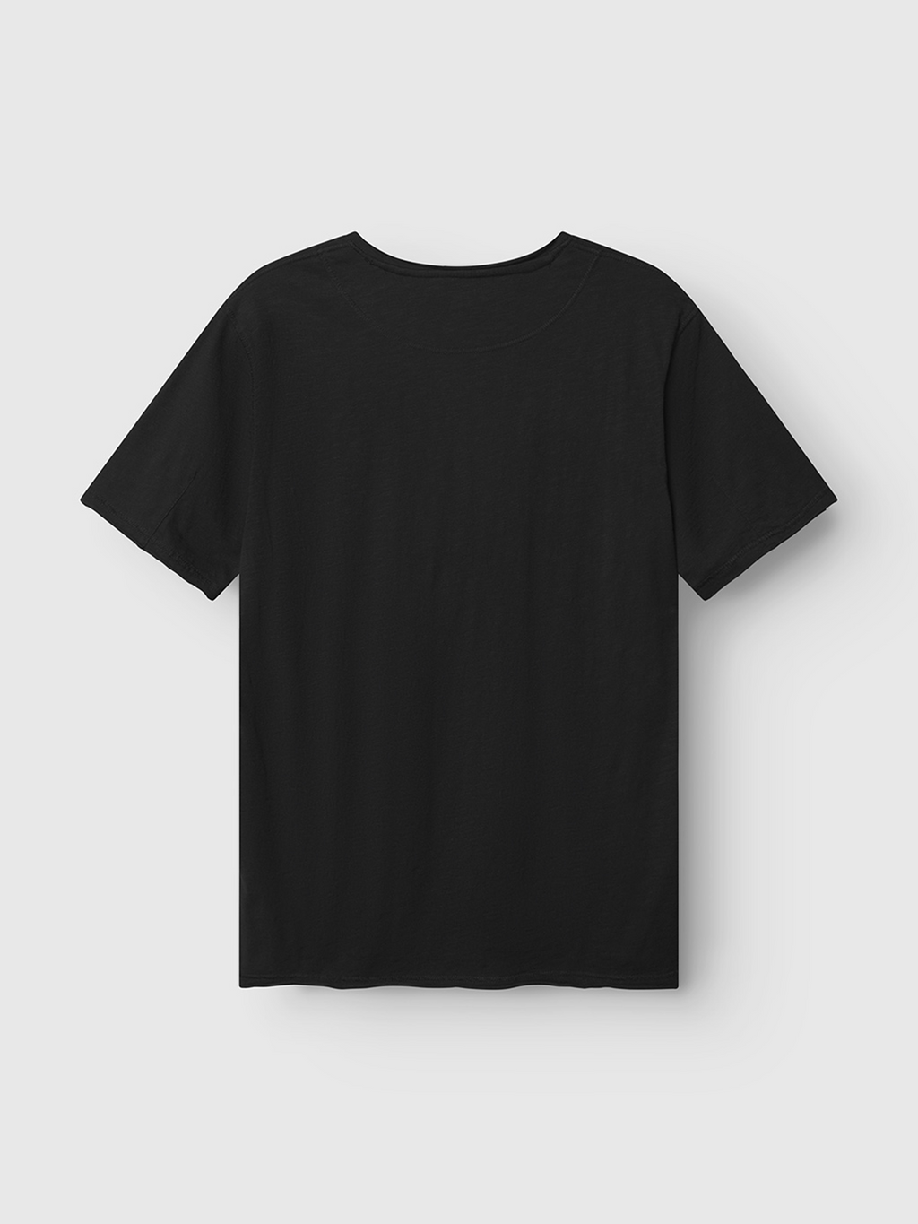 The Gabba Kostant New SS - Meteorite t-shirt, made from black slub fabric with short sleeves, is displayed laid flat on a light gray background, showing its back.