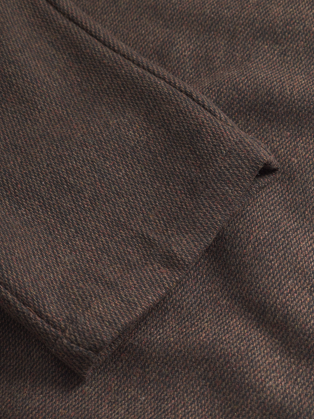 Close-up of Gabba’s Monza Wook - Brown fabric, highlighting the detailed woven herringbone texture and subtle pattern along the folded edge.