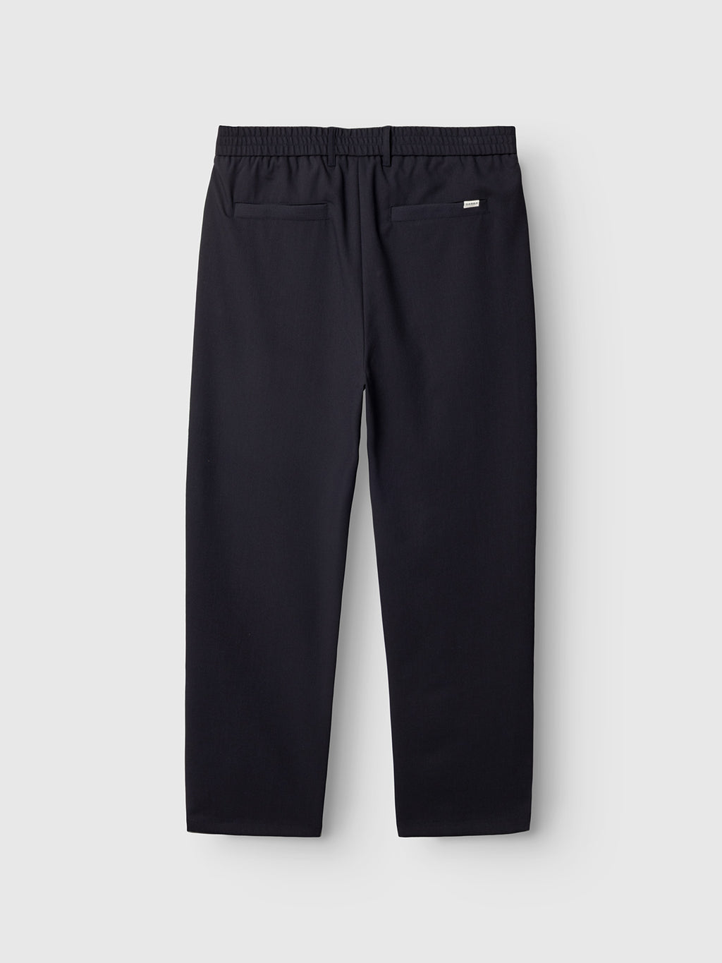 Back view of Gabba Napoli 19 Phin GRS - Navy straight-leg pants, made from recycled wool-blend with elastic waistband and two back pockets—laid flat on a light gray background.