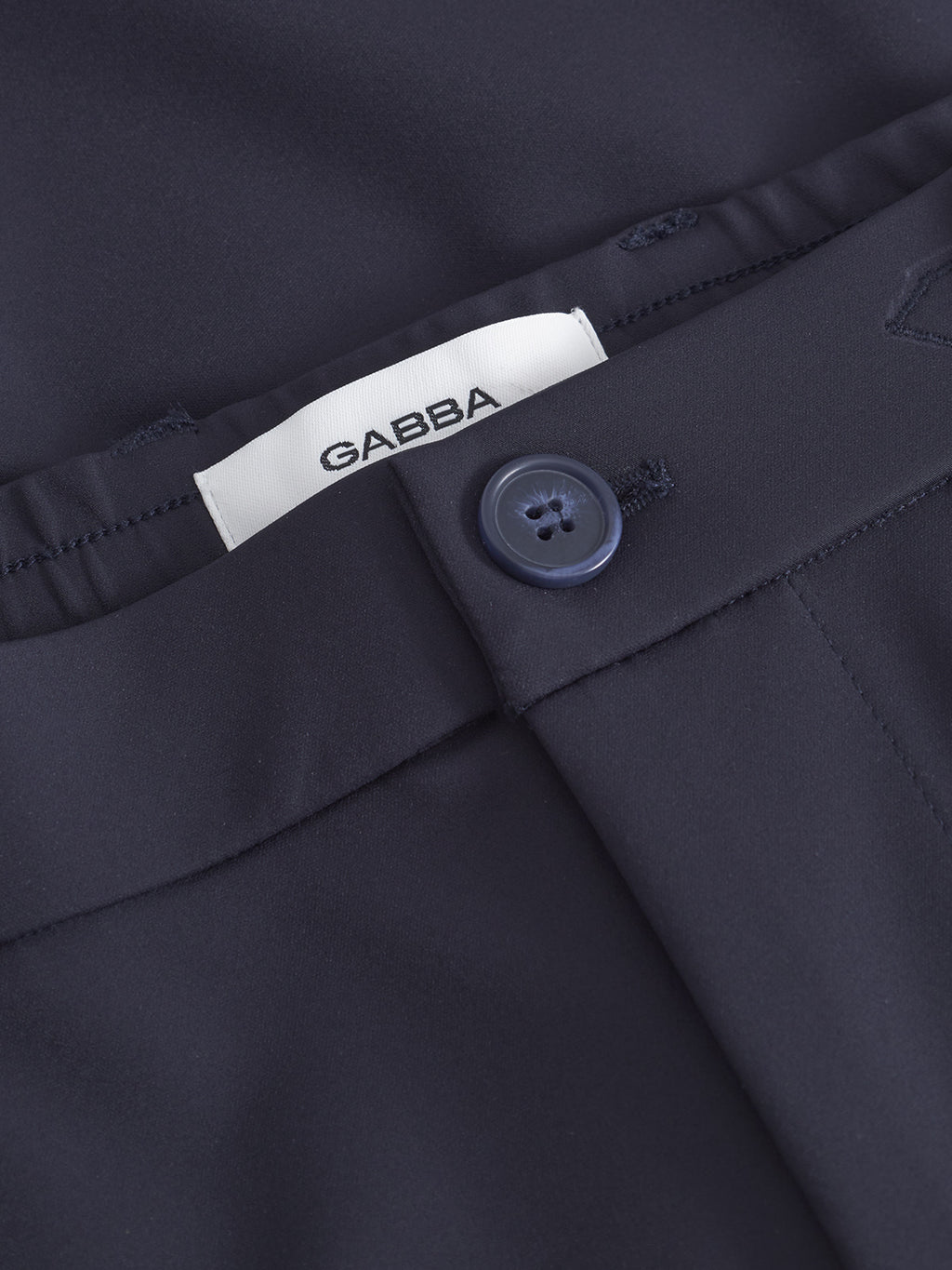 Close-up of Monza Bascu - Navy straight fit pant by Gabba in navy blue, featuring a button closure, wrinkle-resistant fabric, and a visible white Gabba label.